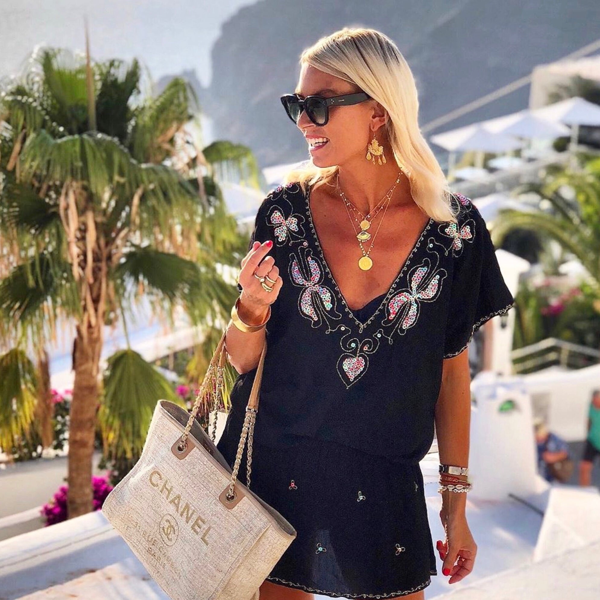 Anna Mavridis wears black designer beach dress by Lindsey Brown resort wear