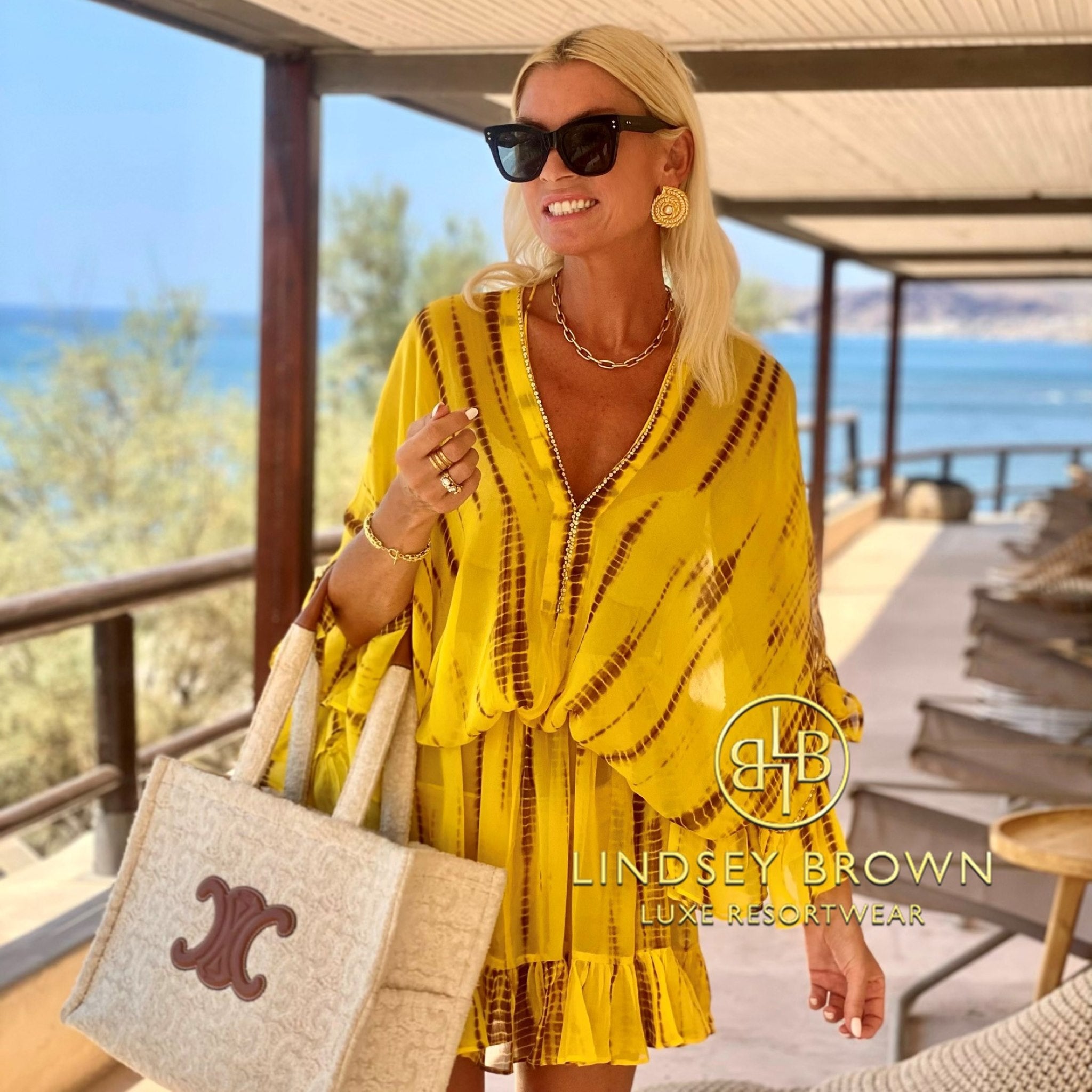 anna mavridis wears yellow silk designer kaftans by lindsey brown luxury resort wear