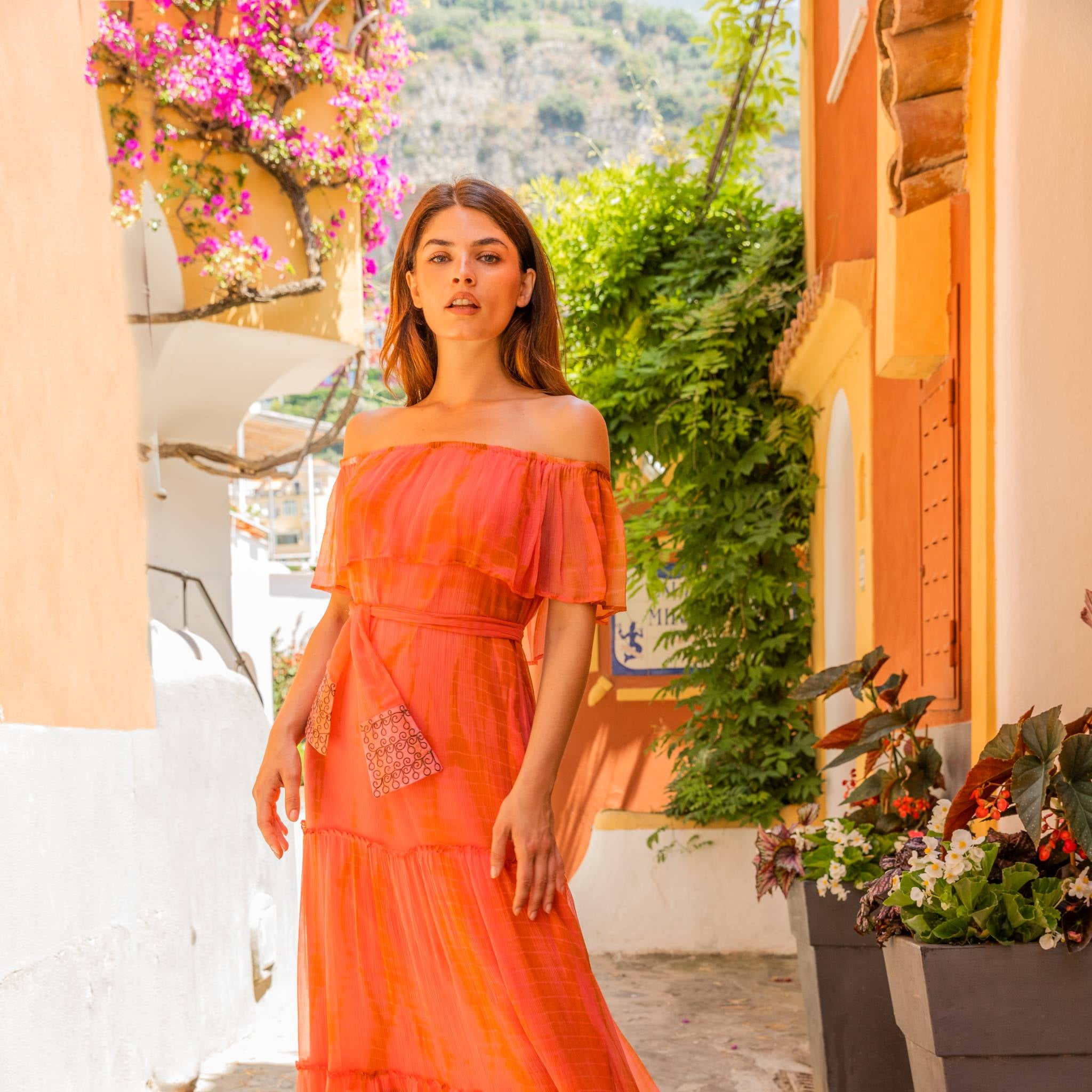 Coral Orange off the shoulder silk maxi dress to wear on holiday by Lindsey Brown luxury resort wear