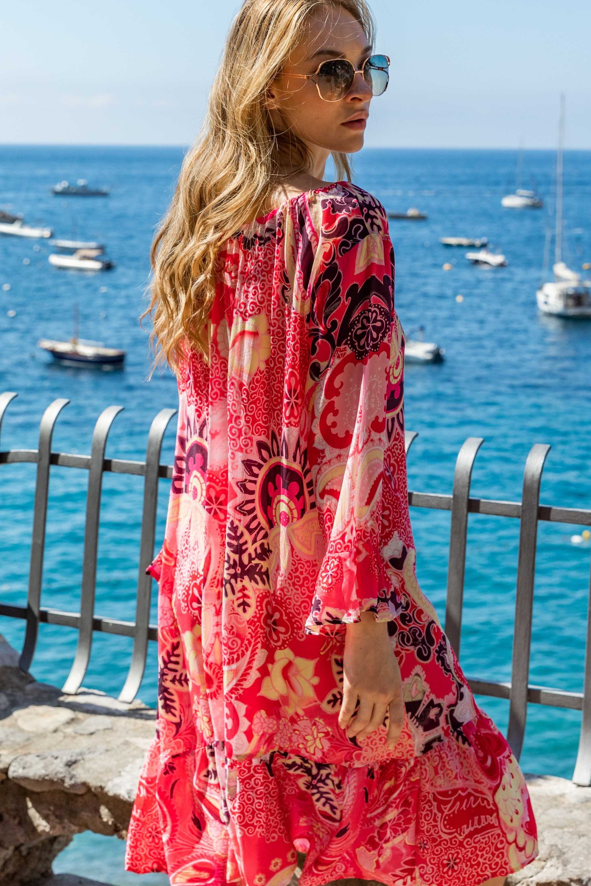 Coral black printed silk knee length dress to wear on holiday by luxury resort wear by Lindsey Brown