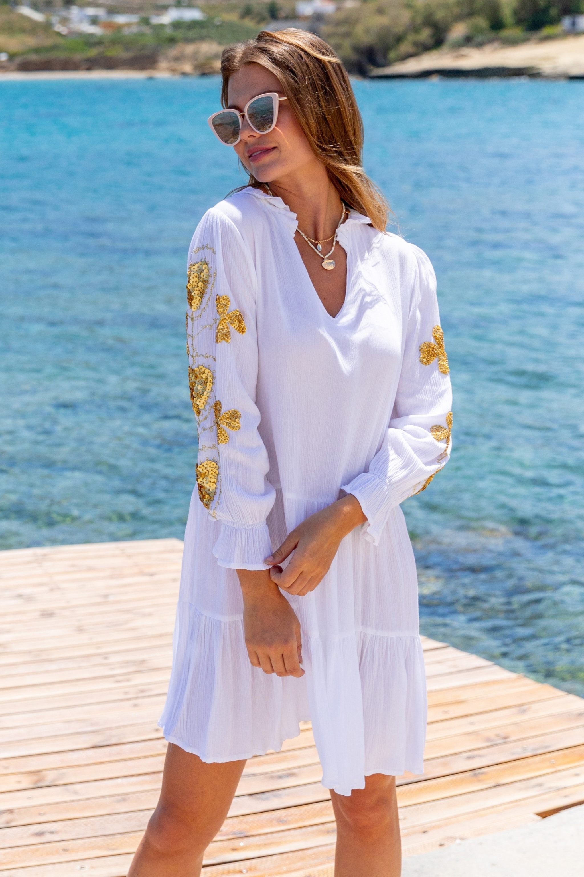 White and gold cotton beach dresses by Lindsey Brown