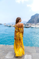 Yellow one shoulder silk maxi dresses to wear on a luxury holiday by Lindsey Brown silk resort