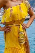 Yellow one shoulder silk maxi dresses to wear on holiday by Lindsey Brown resort wear