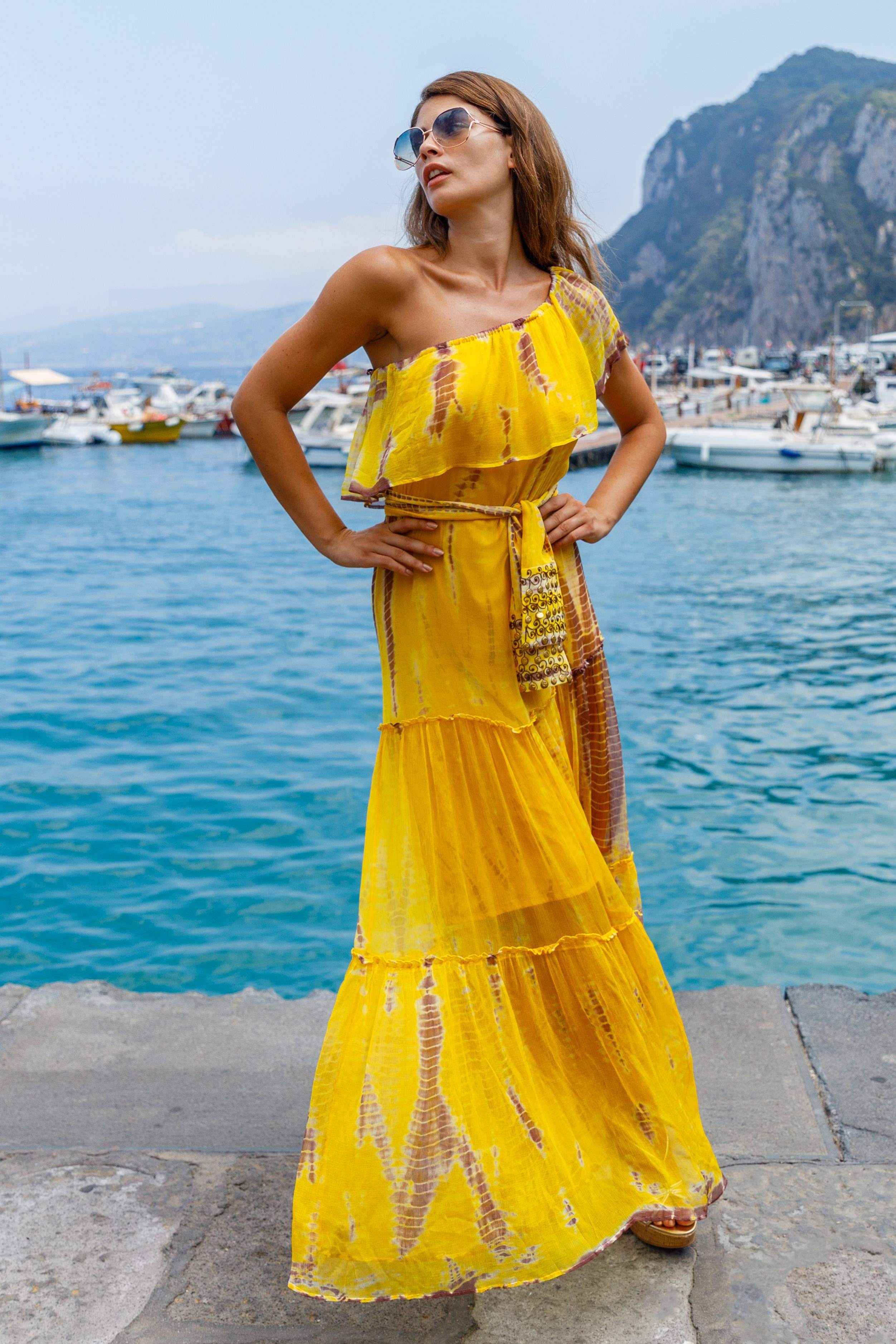 Yellow silk multi way resort wear dress Mykonos by Lindsey Brown resort wear to wear on holiday. Style bardot or on the shoulder as a resort wear holiday dress by Lindsey Brown 