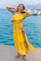 Yellow silk maxi dress to wear on a luxury holiday by Lindsey Brown silk resort