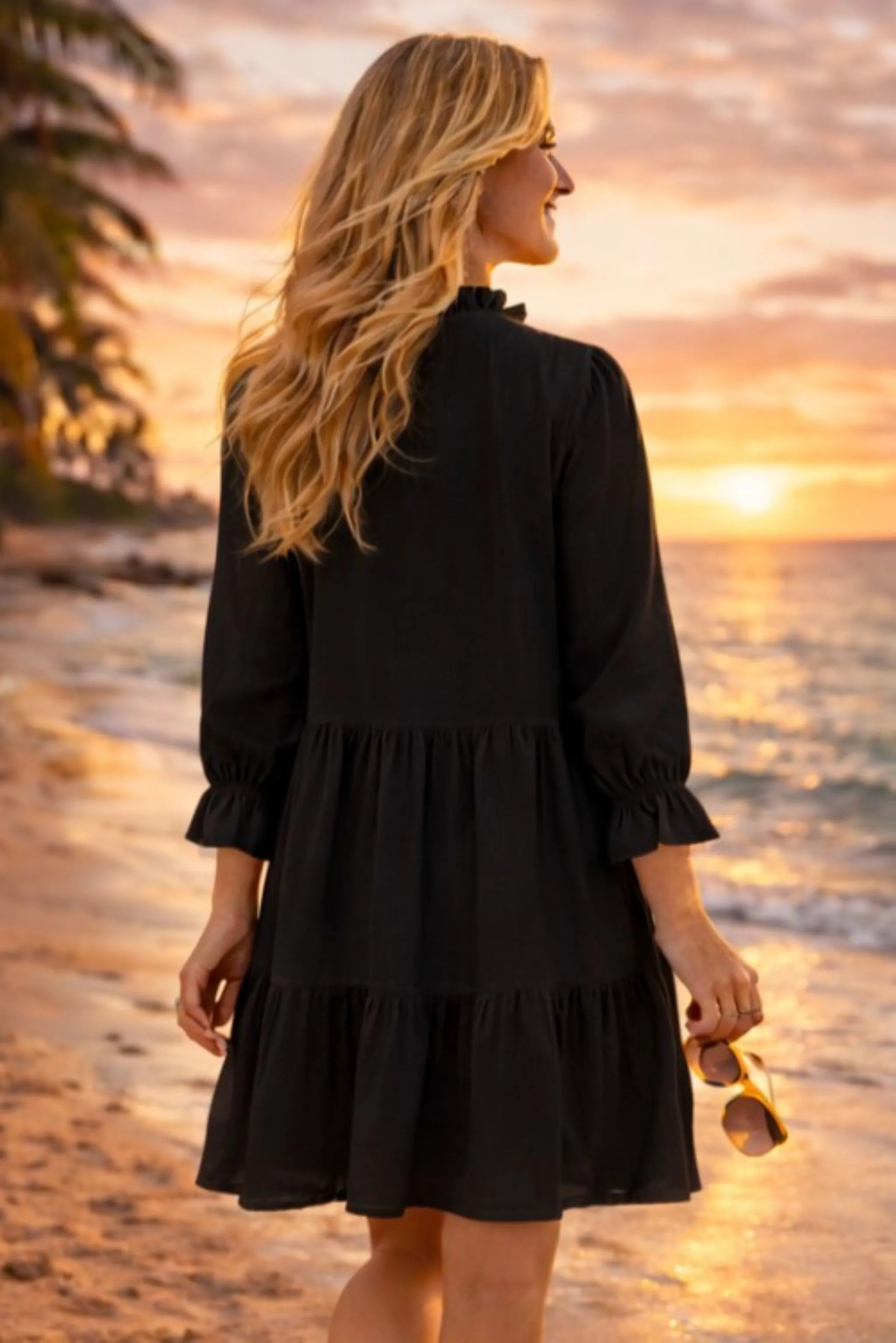 black long sleeved beach dress to wear on a luxury beach holiday