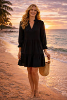 black cotton long sleeved beach dress to wear on a luxury beach holiday