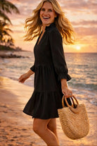 black cotton long sleeved beach dress to wear on a luxury beach holiday in the Caribbean