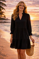 black cotton long sleeved beach dress to wear on a luxury beach holiday
