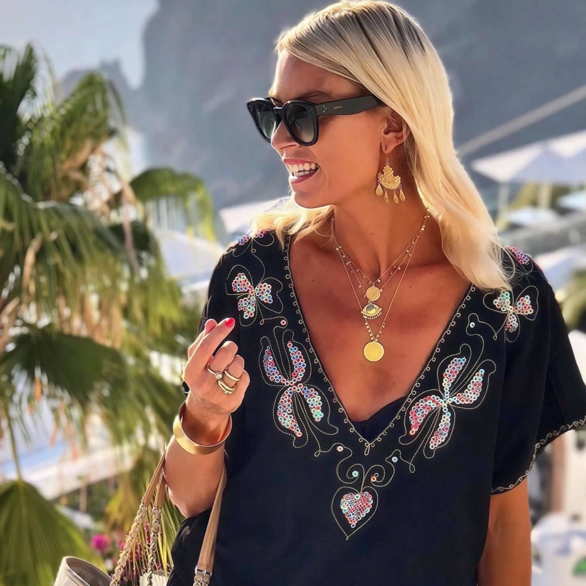 black bloused cotton v neck beach dress to wear on holiday by lindsey brown luxury cotton resort wear