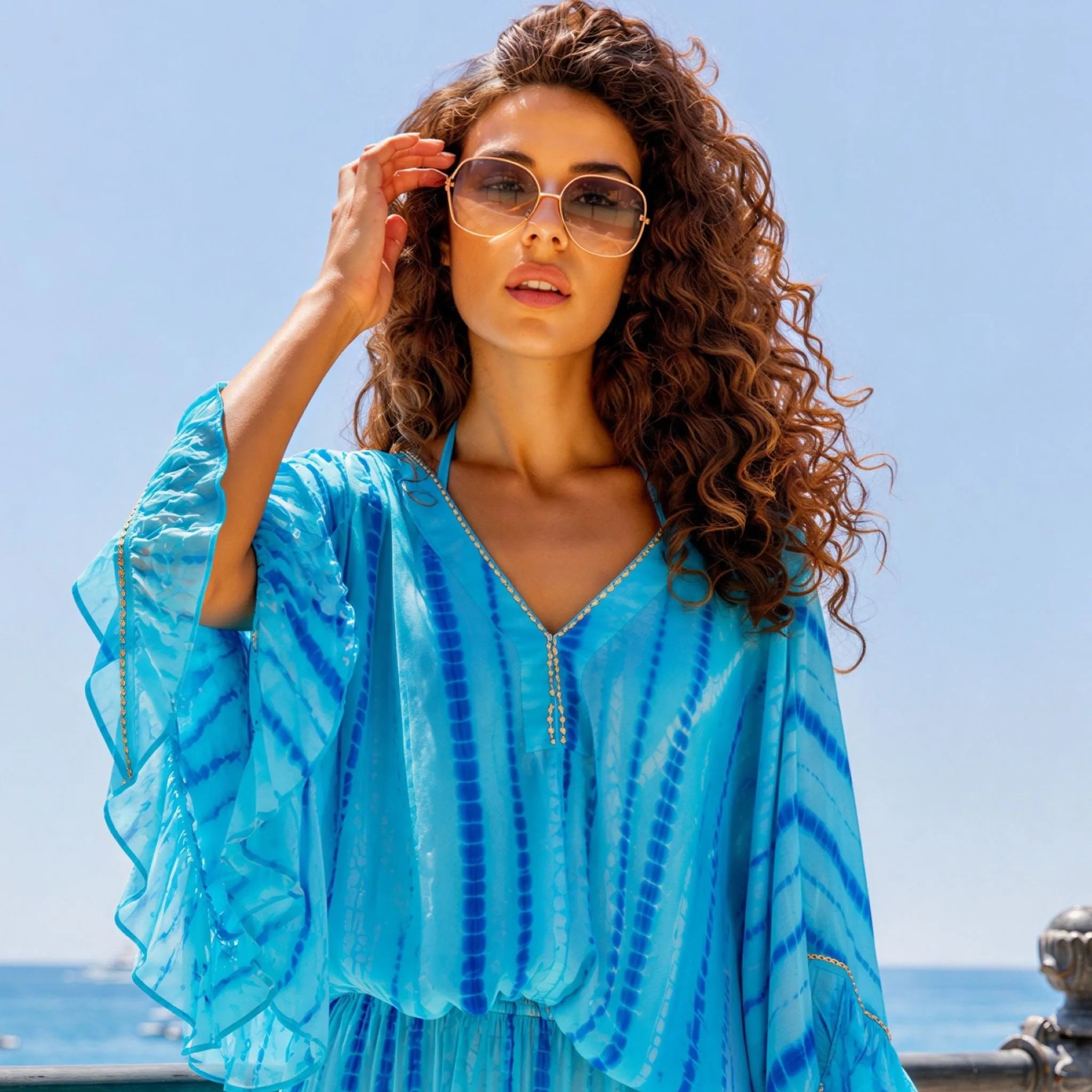 turquoise and blue v neck silk bloused kaftan dress to wear on a luxury holiday by lindsey brown