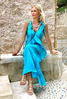 SeenOnSarah wears turquoise silk maxi dress to wear on holiday by Lindsey Brown resort wear dark turquoise silk resort wear dress by lindsey brown resort wear