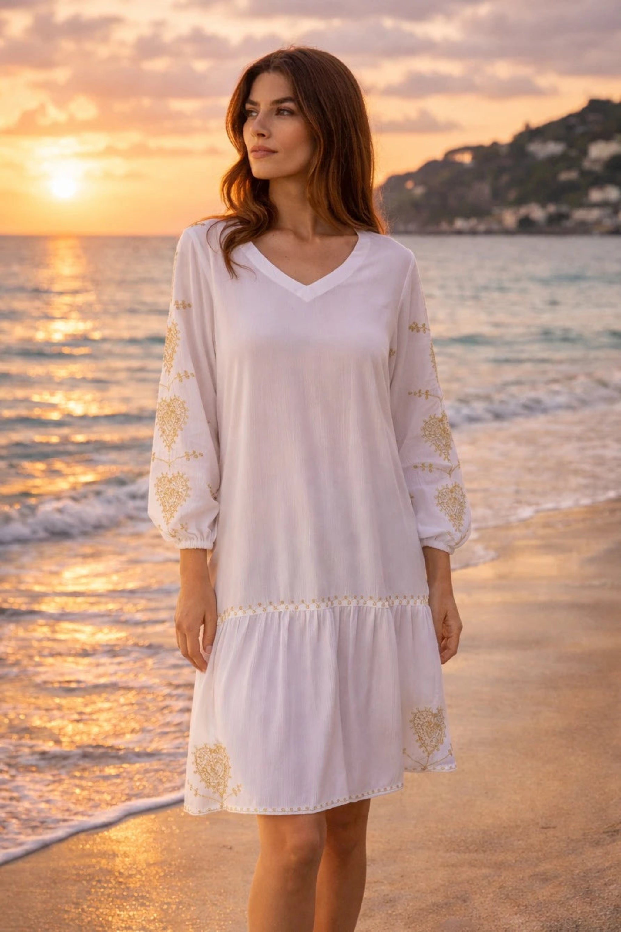 white v neck knee length belted beach dress with gold embroidery by lindsey brown resort wear