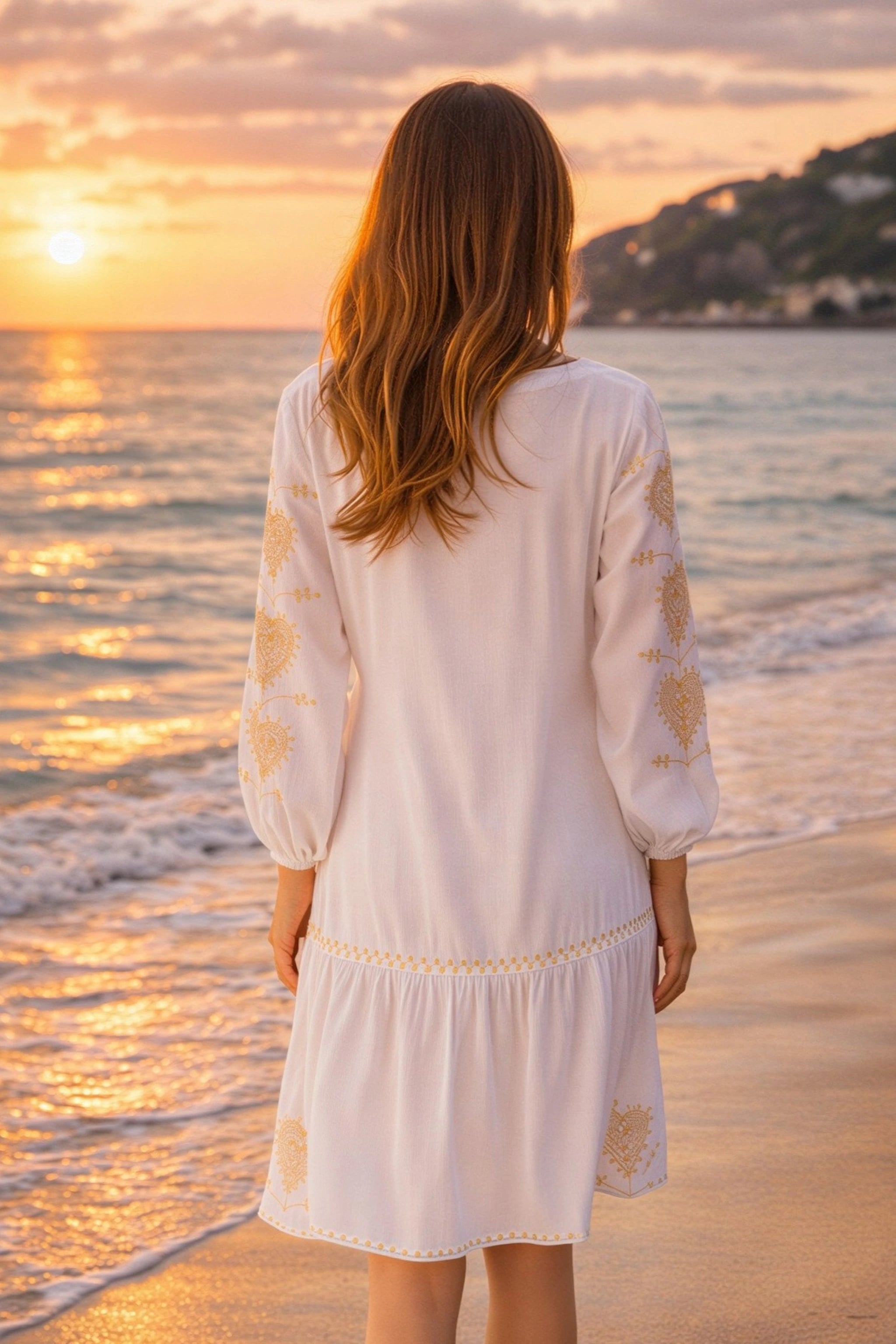 white cotton beach dress with long sleeves to wear in summer on holiday