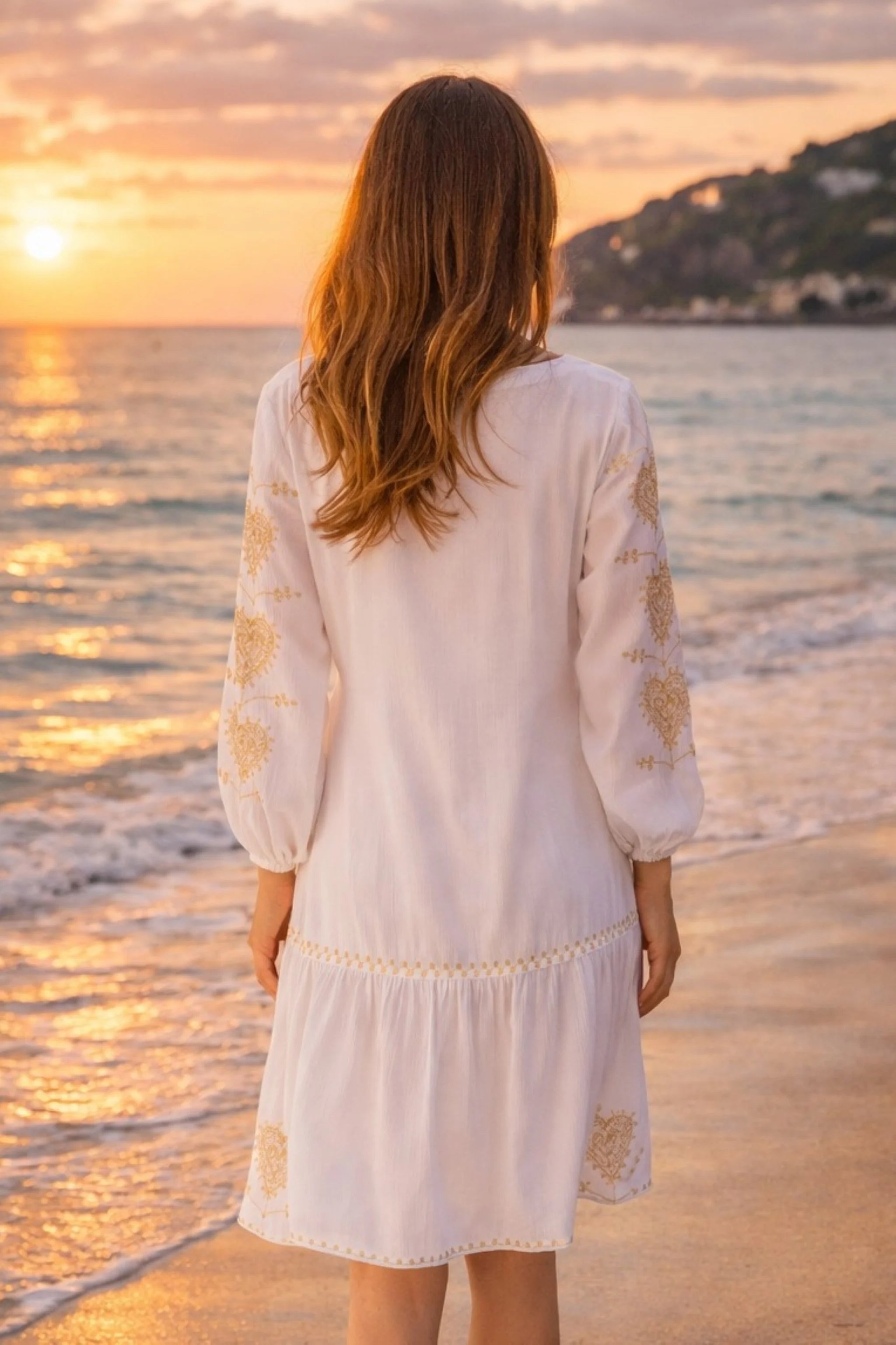 back view of the white knee length beach dress to wear at sunset by lindsey brown resort wear