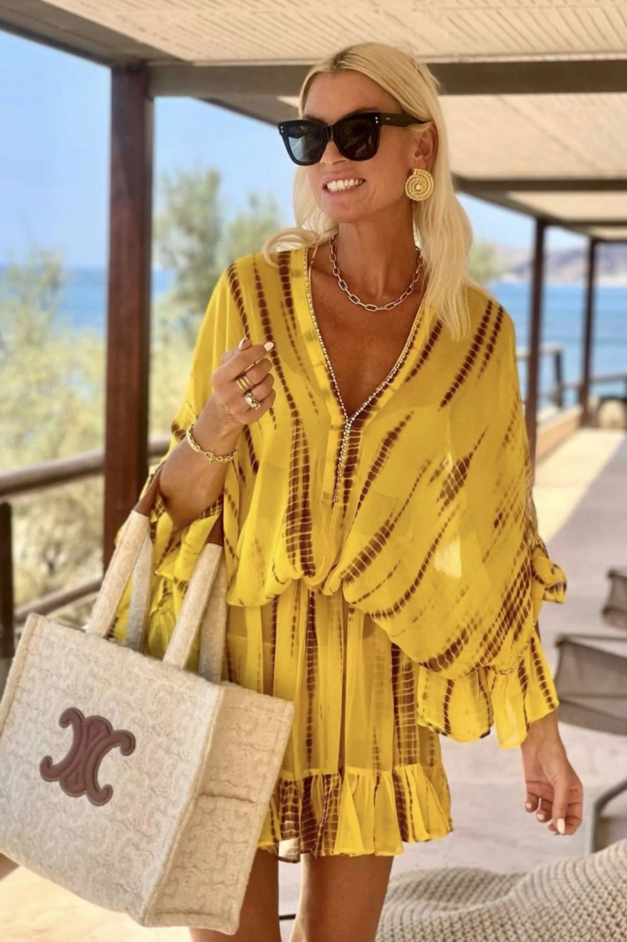 yellow silk designer kaftan dress to wear on a luxury holiday by Lindsey Brown resort wear