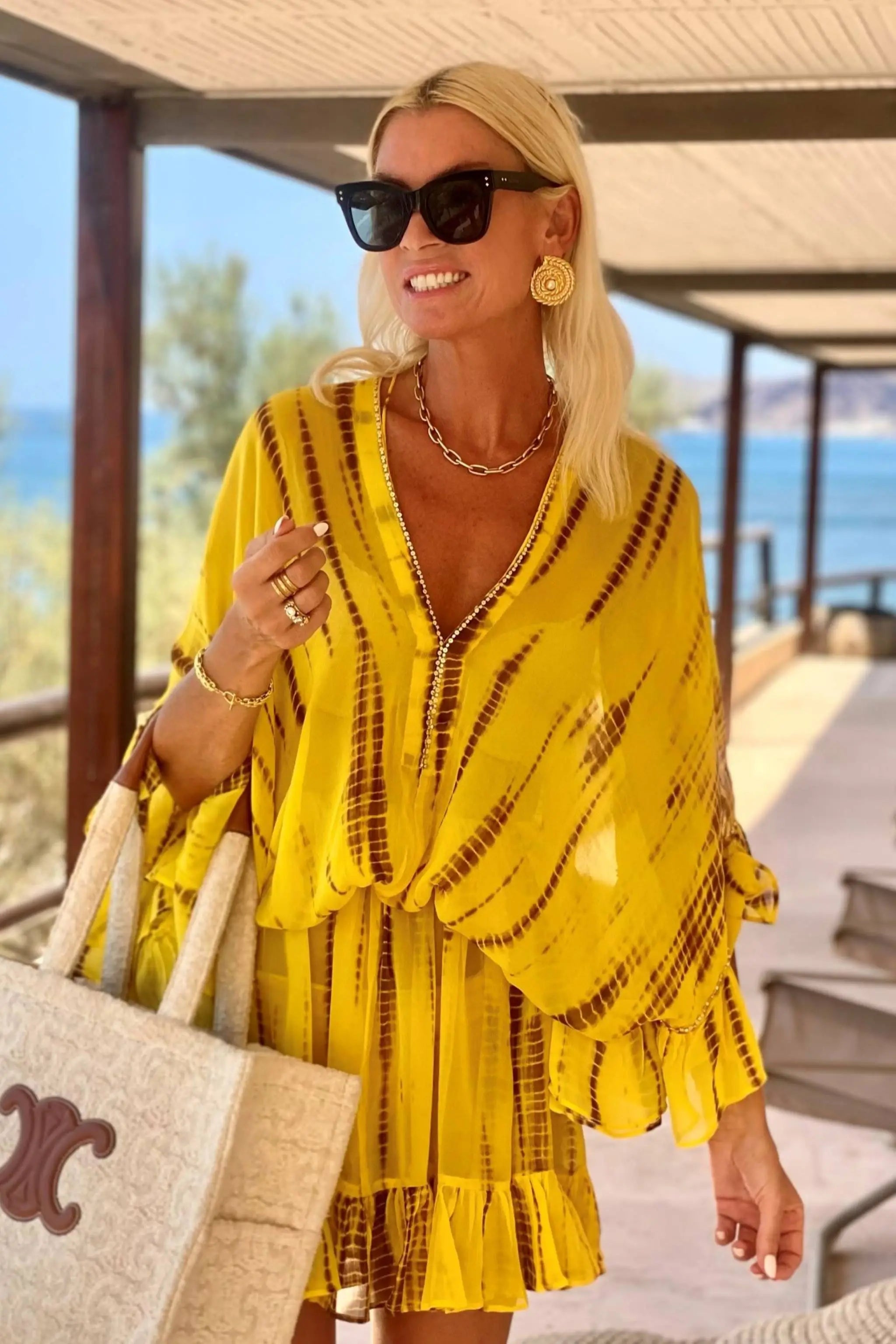 yellow silk designer kaftans to wear on holiday by Lindsey Brown luxury resort wear