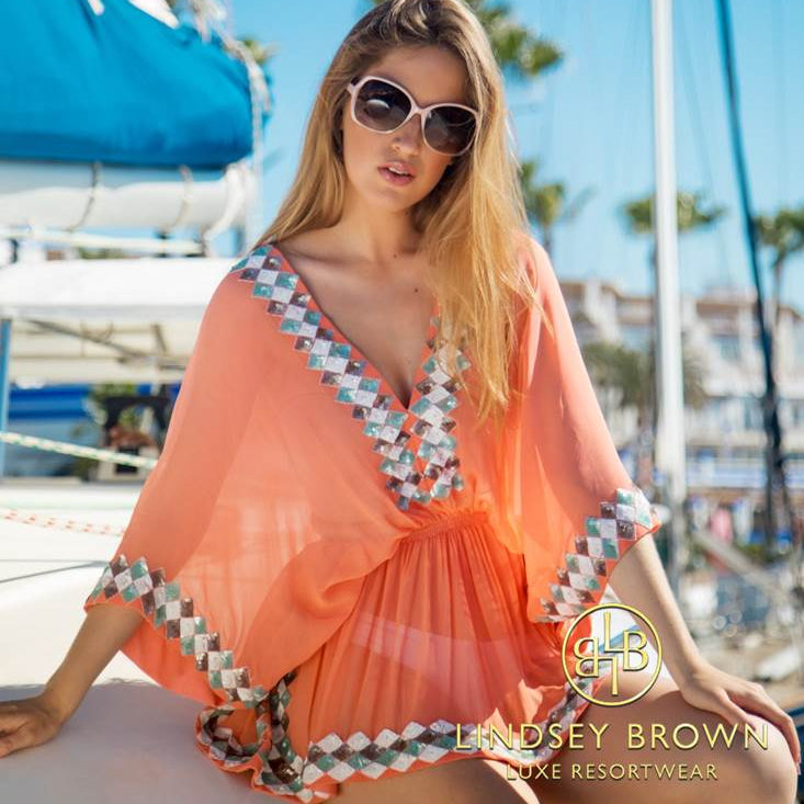 Anna Mavridis wears orange silk designer kaftan by Lindsey Brown resort wear 