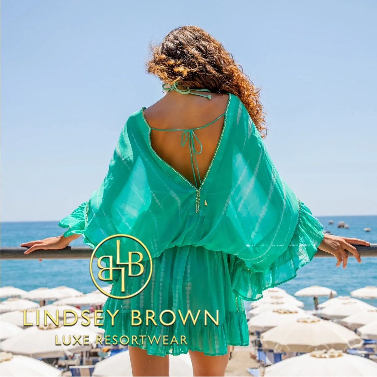 Lindsey Brown luxury resort wear aqua silk bloused kaftans to wear over swimwear on a luxury beachside resort