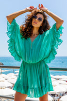Aqua bloused silk tie dye designer kaftan beach dress, in a drop waisted silk kaftan, with a pretty ruffled hemline, decorated by hand with gold beads by Lindsey Brown.