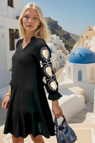 Black cotton knee length dress with gold sequin detail on sleeves by Lindsey brown cotton resort wear 