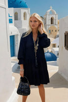Black cotton long sleeved designer dress to wear in summer by Lindsey Brown resort wear 