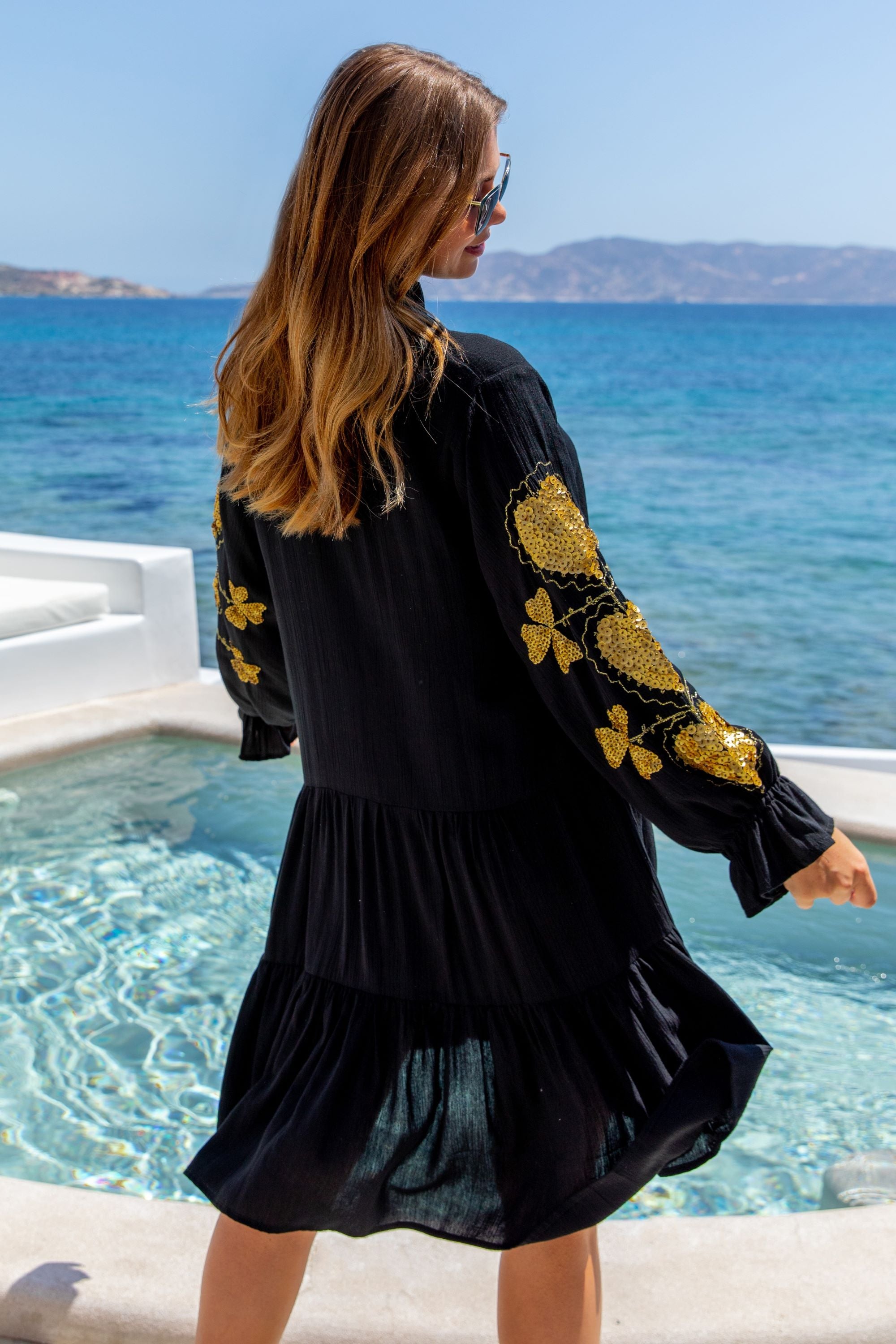 Black cotton dress with gold sleeve detail by Lindsey Brown resort wear 