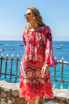 Coral black printed silk knee length dress to wear on holiday by Lindsey Brown