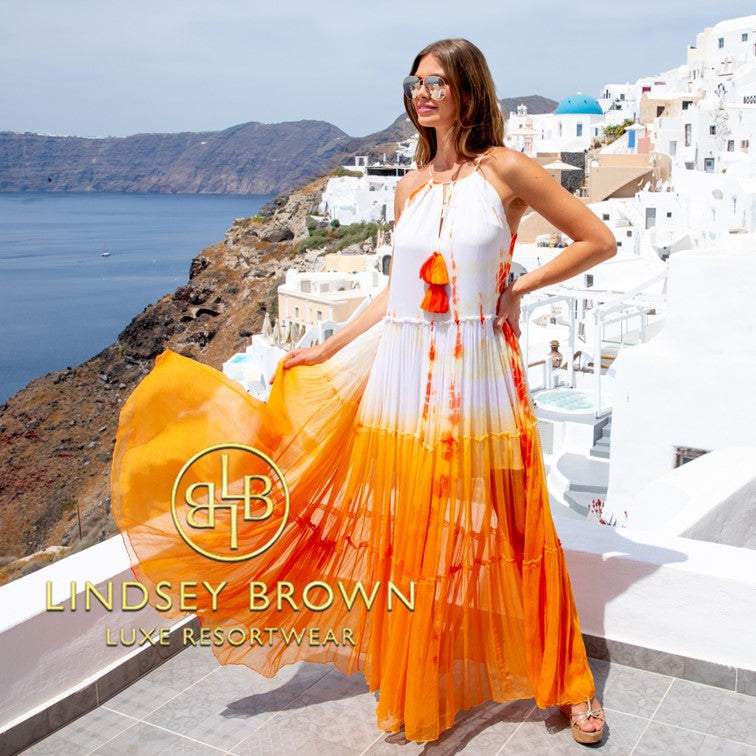 Orange silk maxi dresses to wear on holiday by Lindsey Brown luxury resort wear, silk tie dye floaty dresses to wear in Santorini