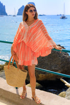 Orange silk luxury kaftan dress to wear on holiday by Lindsey Brown luxury resort wear 