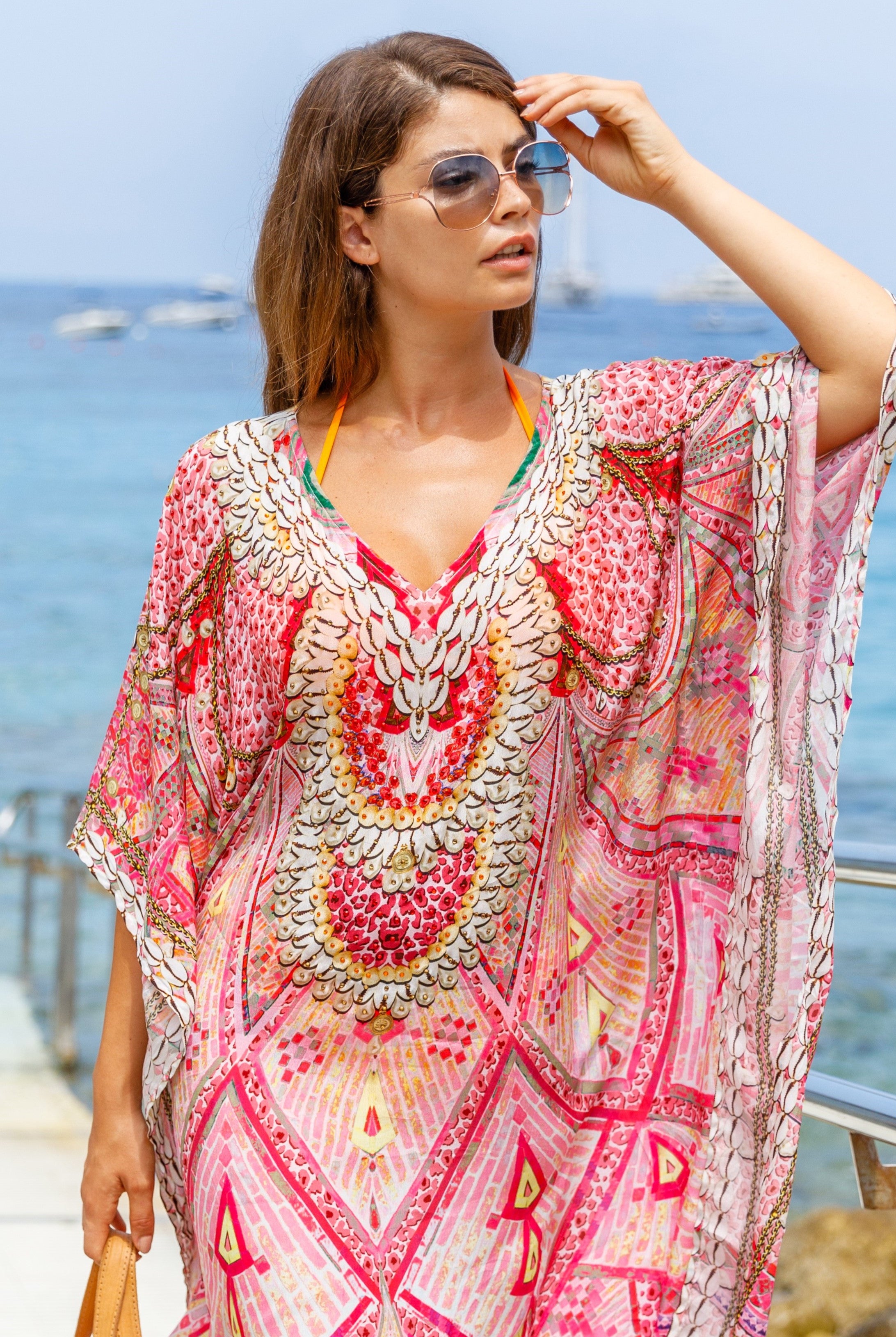 Pink silk designer kaftan to wear on luxury holidays by Lindsey Brown luxury resort wear .