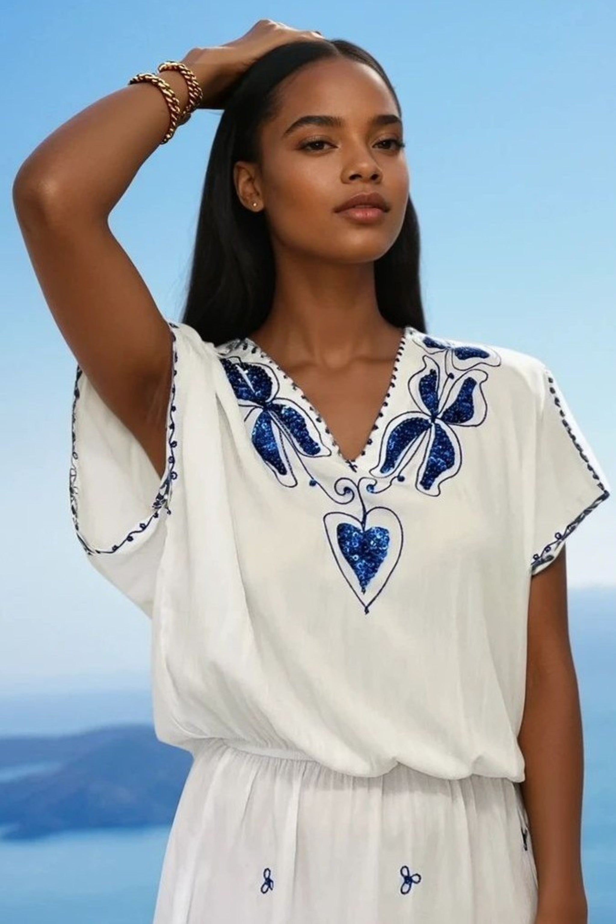 White cotton beach dresses with bright blue embroidery by Lindsey Brown