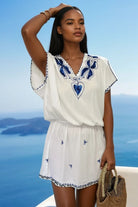 White cotton beach dresses with bright blue embroidery by Lindsey Brown resort wear 