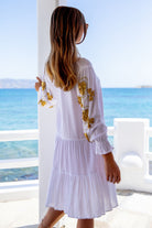 White cotton beach dress with gold embroidery by Lindsey Brown resort wear 
