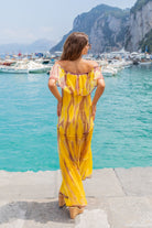 Yellow silk bardot maxi dresses to wear on holiday by Lindsey Brown luxury resort wear