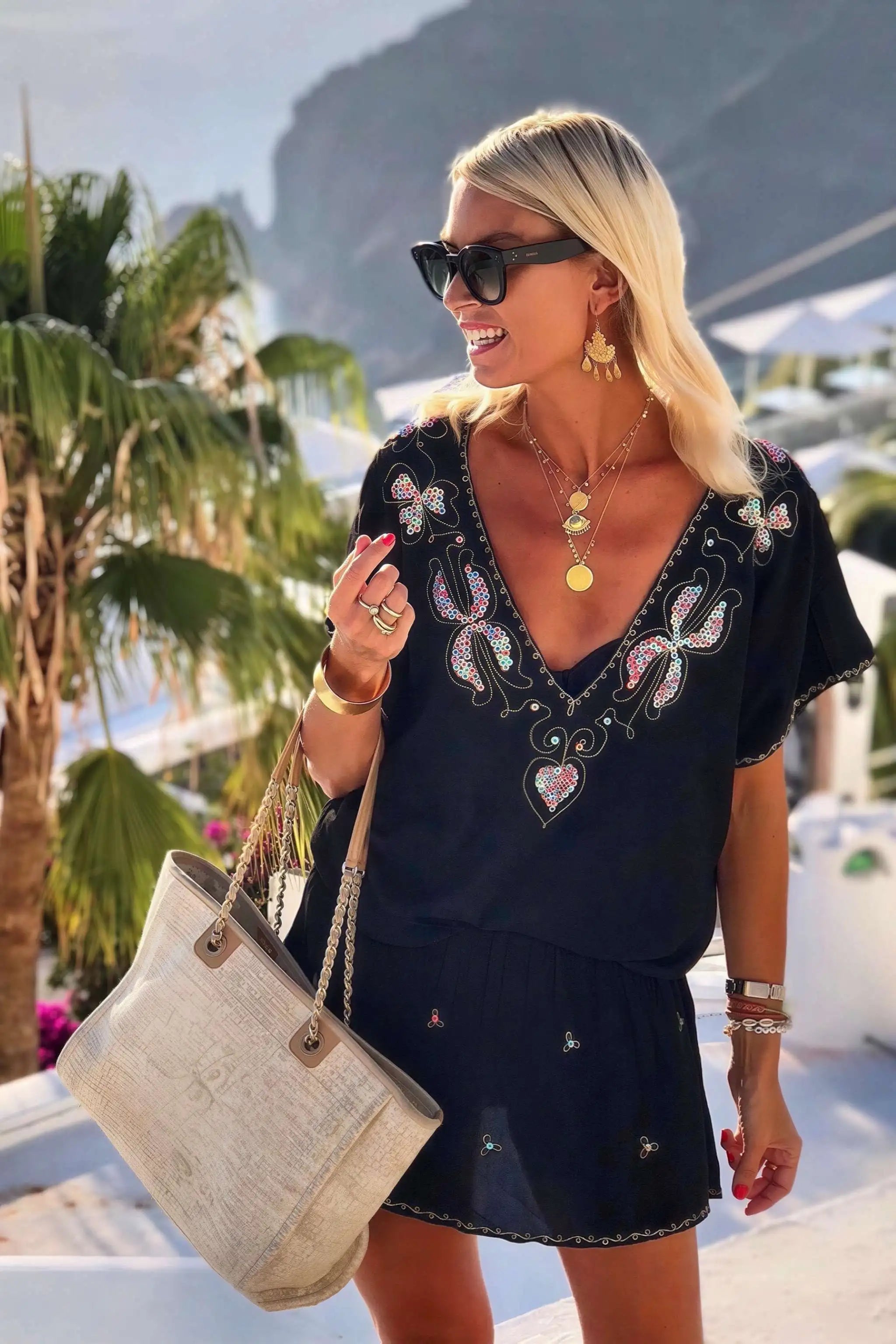 black bloused cotton v neck beach dress to wear on holiday by lindsey brown resort wear 