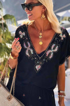 black bloused cotton v neck beach dress to wear on holiday with gold hand embroidery and coral sequins