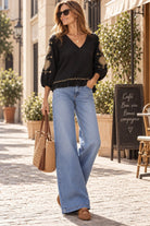 black cotton loose fitting blouse with gold embroidery by Lindsey Brown resort wear