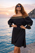 black off the shoulder dress to wear on holiday by Lindsey Brown