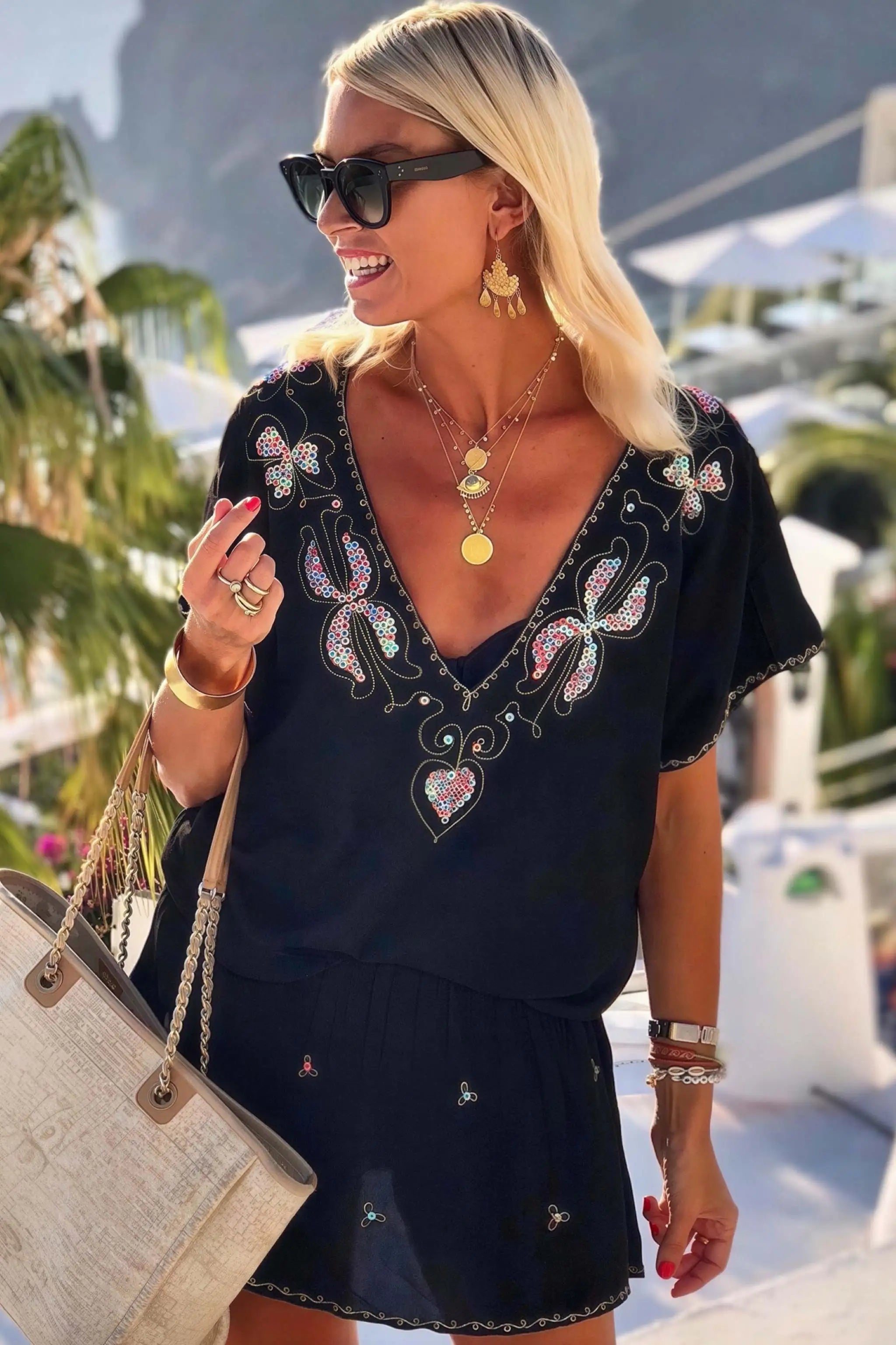black bloused cotton v neck designer beach dress to wear on holiday by lindsey brown luxury cotton resort wear 