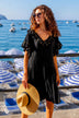 black v neck short sleeved designer beach dress to wear on holiday by lindsey brown resort ear 