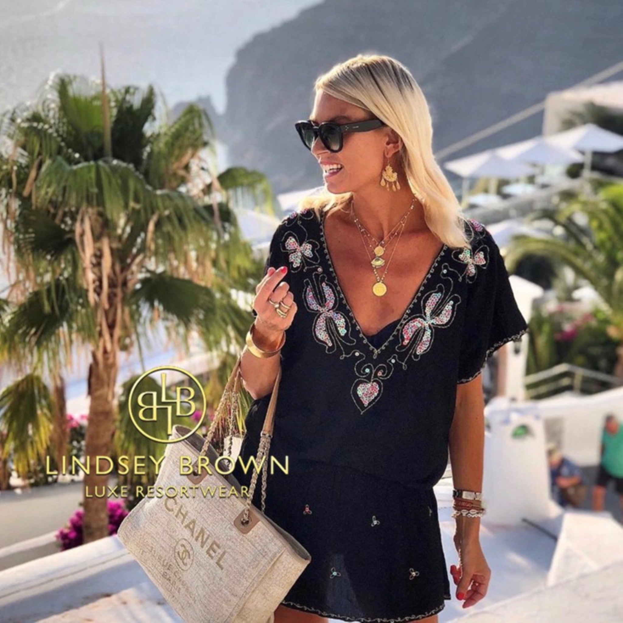 Black cotton bloused drop waisted beach dresses to wear on holiday by Lindsey Brown cotton resort wear 