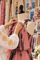 Lindsey Brown, fashion designer in her design studio altering dresses