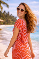 orange and pink printed silk crepe midi dress to wear on a warm holidays