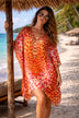 orange and red animal printed silk beach coverup to wear on a  luxury holiday 
