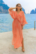orange silk maxi kaftans to wear on vacation by Lindsey Brown