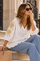 white blouse with gold embroidered sleeves by Lindsey Brown