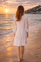 white cotton beach dress with long sleeves and gold sleeve motifs to wear in summer on holiday 