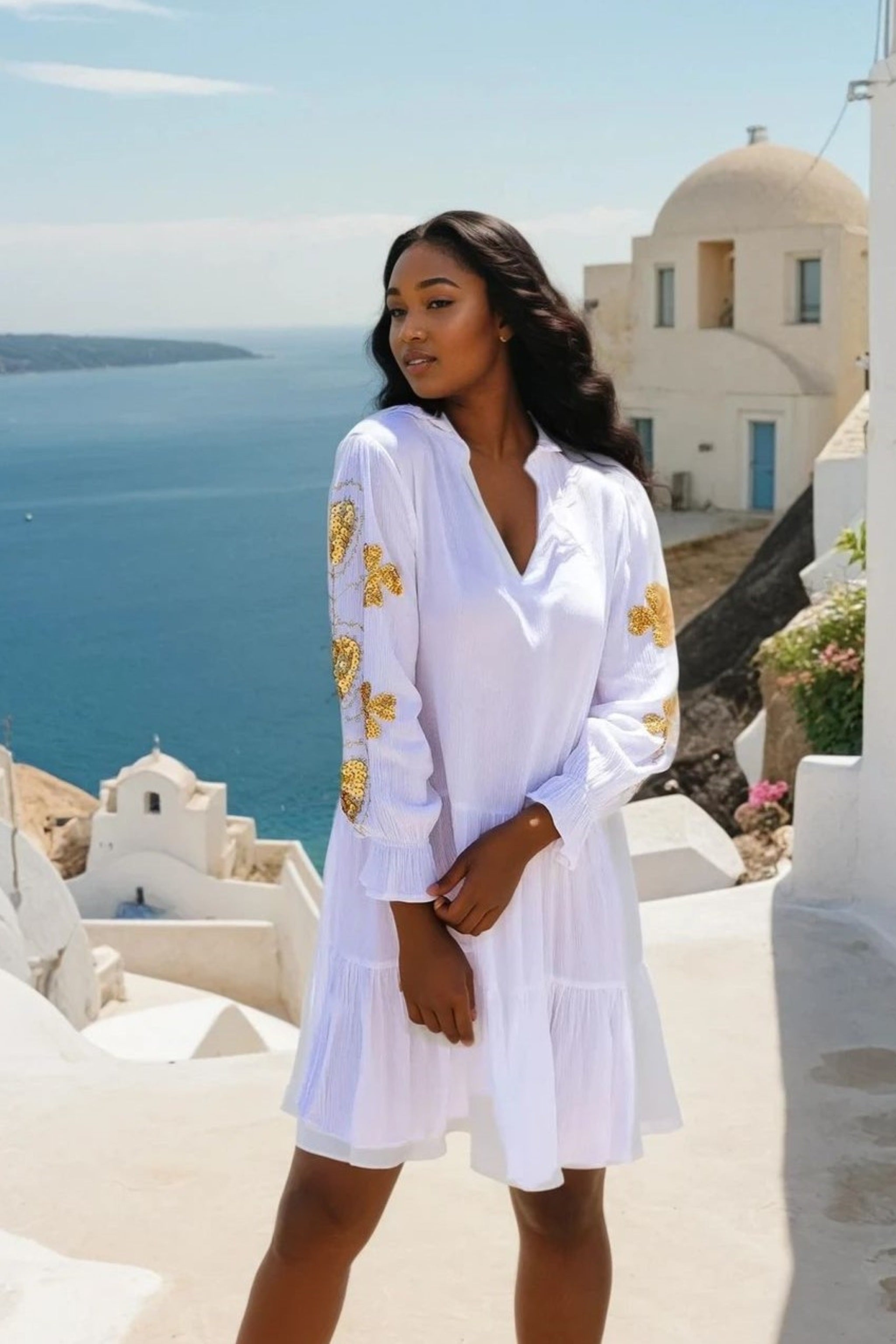 white gold cotton dress with long sleeves and gold embroidery to wear in summer and on holiday by Lindsey Brown 