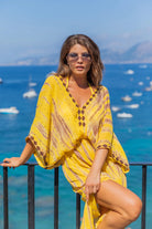 Yellow silk luxury maxi kaftans to wear on vacation by Lindsey Brown resort 